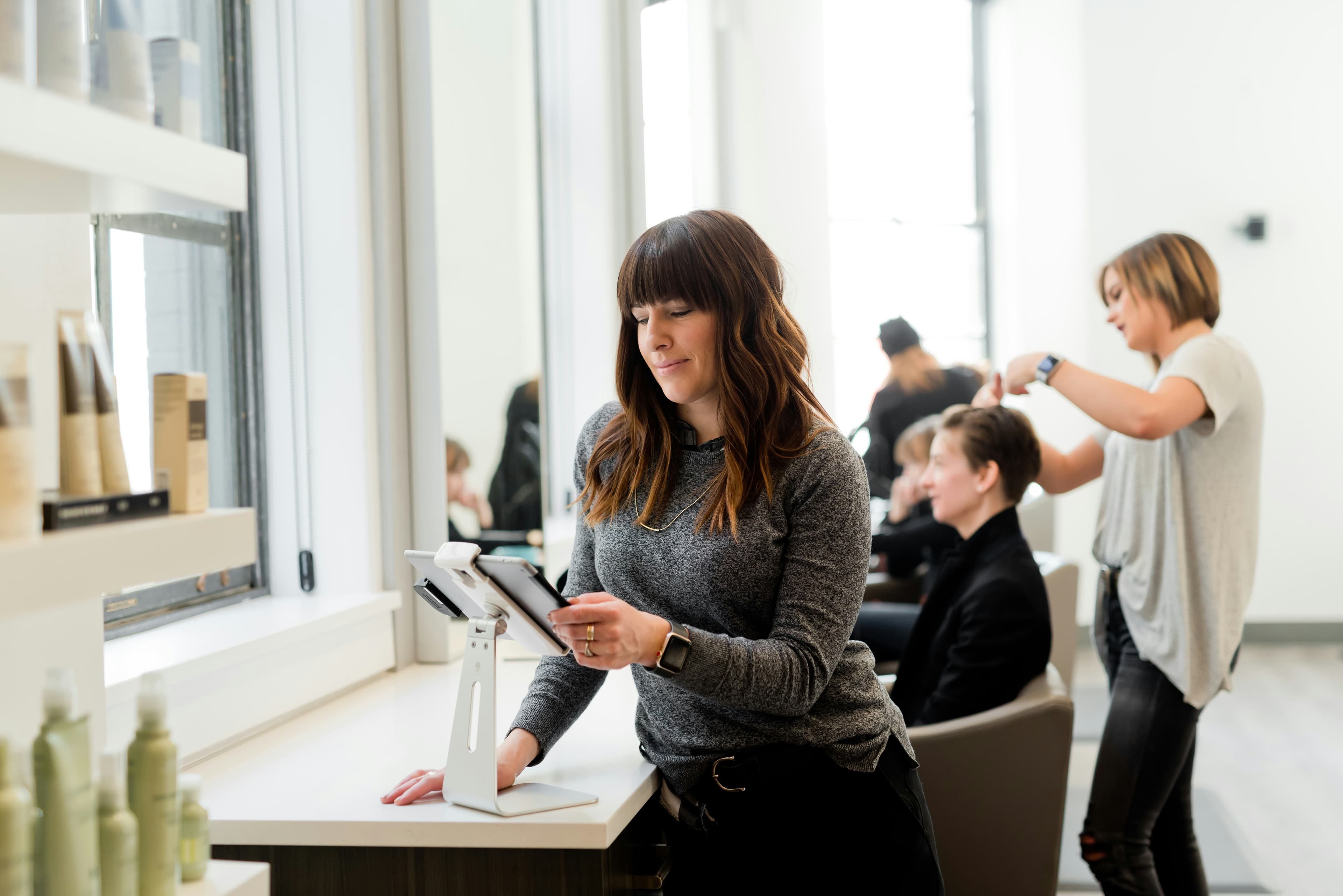 Woman looking at tablet in a salon. Business owner, female entrepreneur.  

Kulør Hair Design and Color Studio is the best place for hair styling, located at 22 East Center Street in Logan, Utah. 
https://www.instagram.com/kulorsalon/
https://www.kulorsa…