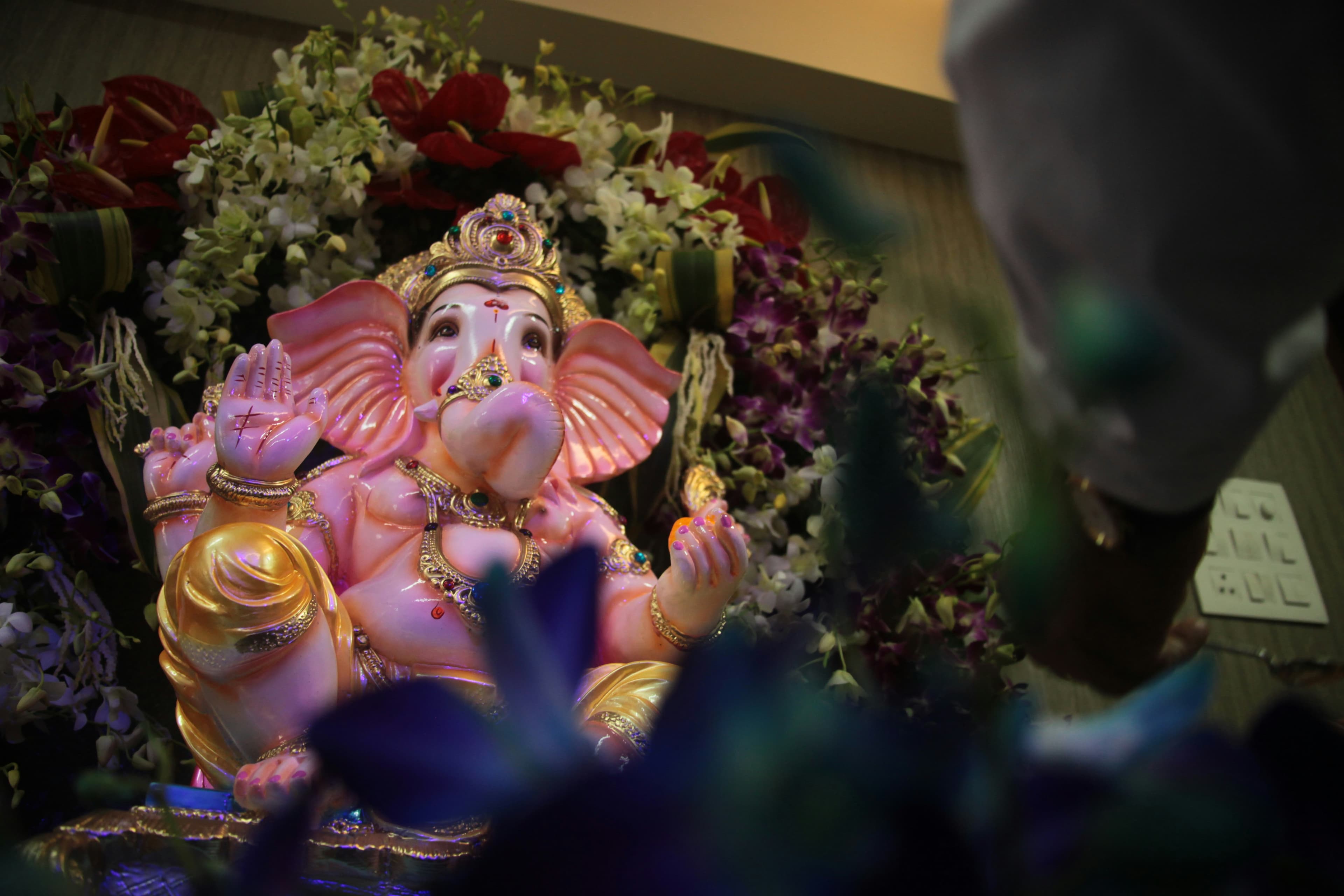 gold and pink hindu deity figurine