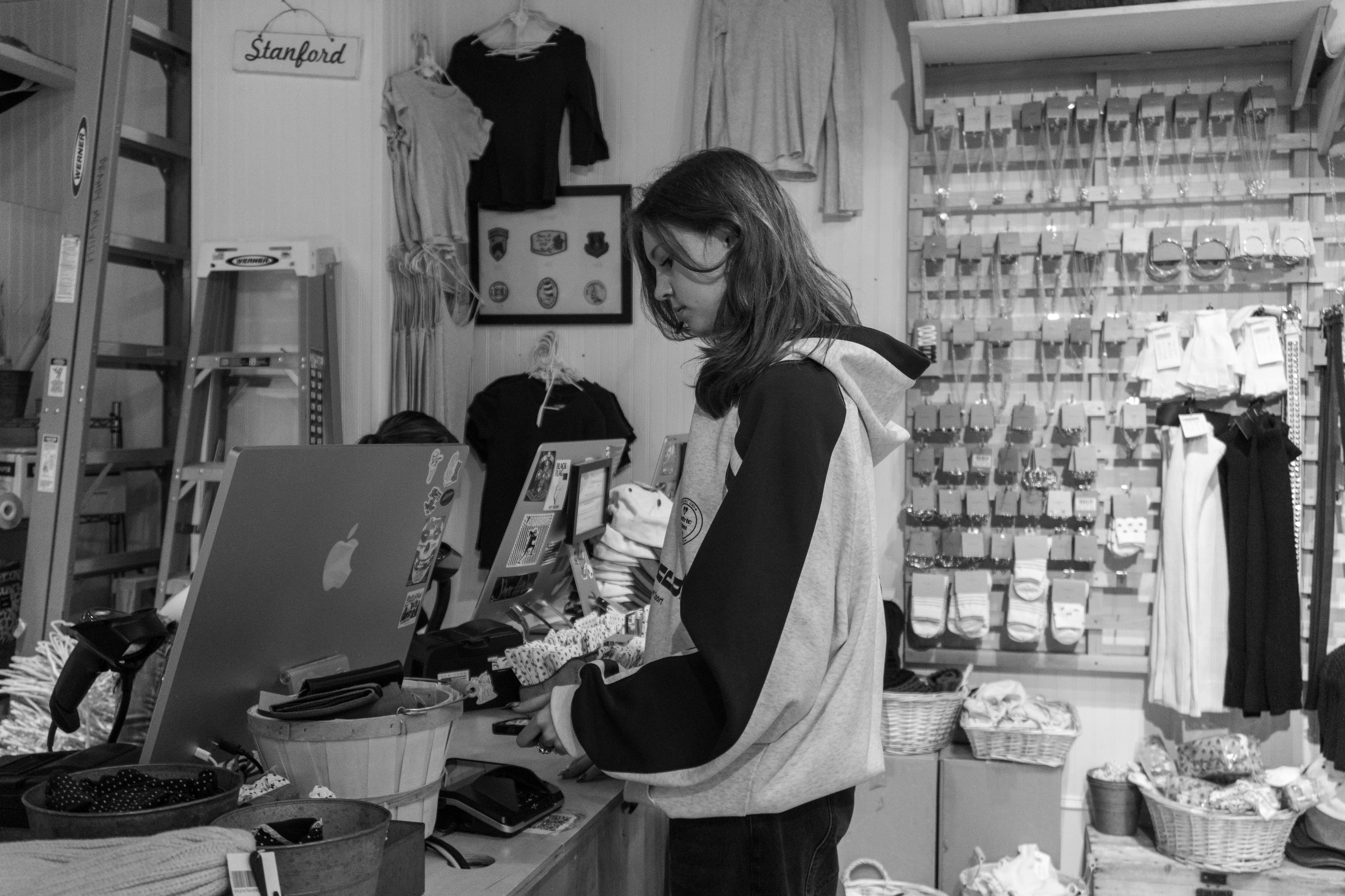 A woman standing at a counter in a store