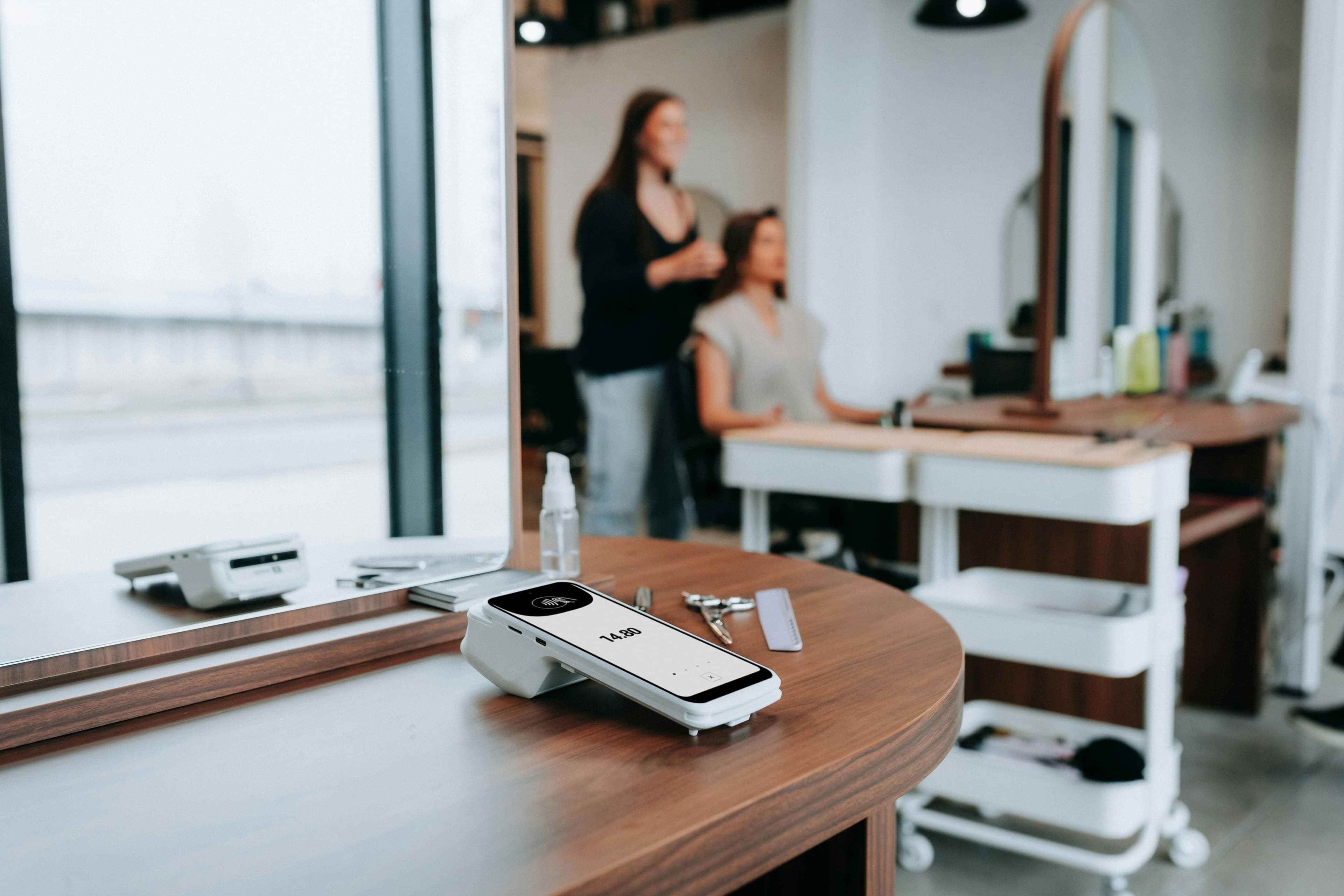 Salon scene: a haircut and credit card reader.