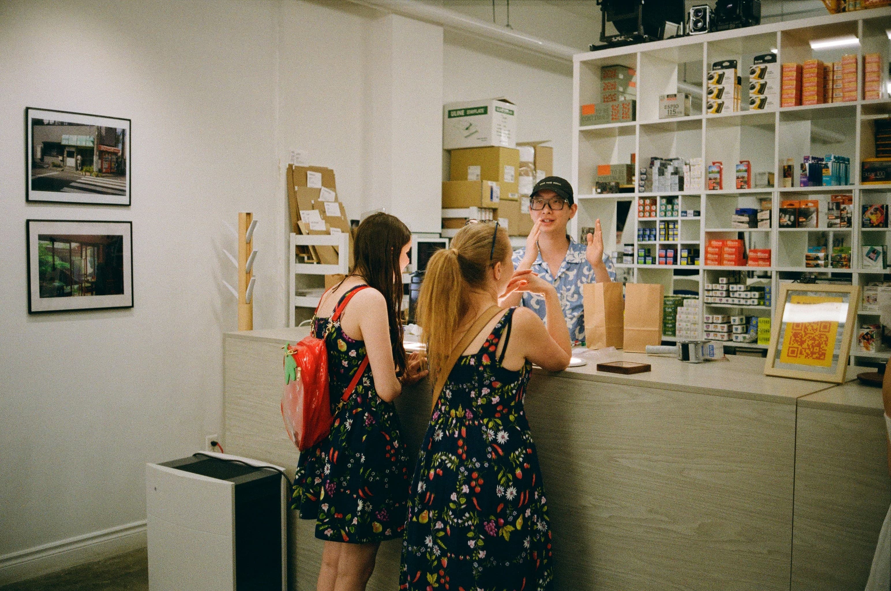 Customers are at the counter, being assisted by an employee