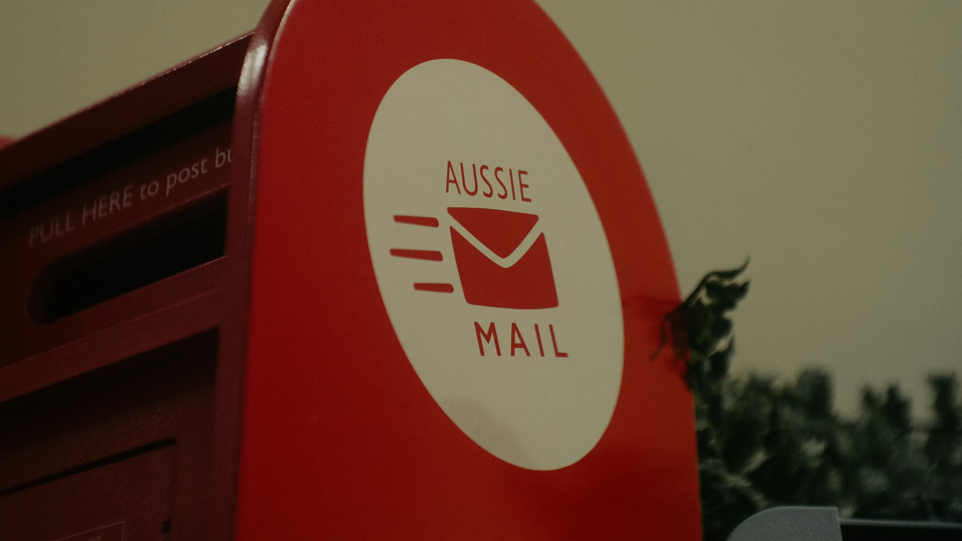 Red aussie mailbox with envelope logo